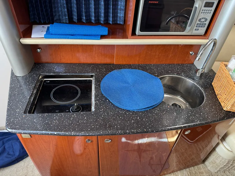 Slide: The Image of Galley with sink, stove, and microwave in a boat. - 41
