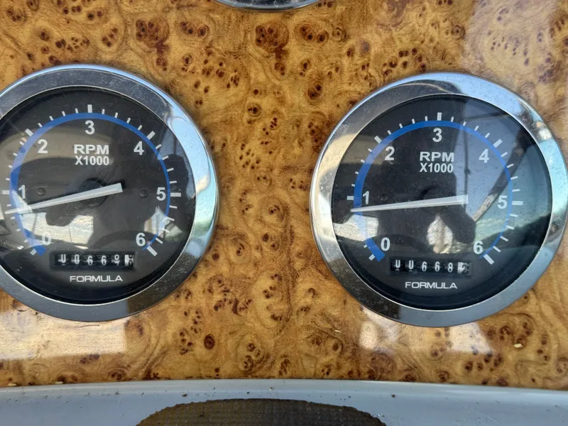 Slide: The Image of Two RPM gauges on a wooden dashboard, displaying revolutions per minute. - 42