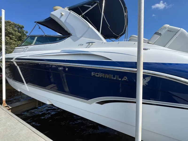 Slide: The Image of A blue and white boat with an open canopy docked at the pier. - 6