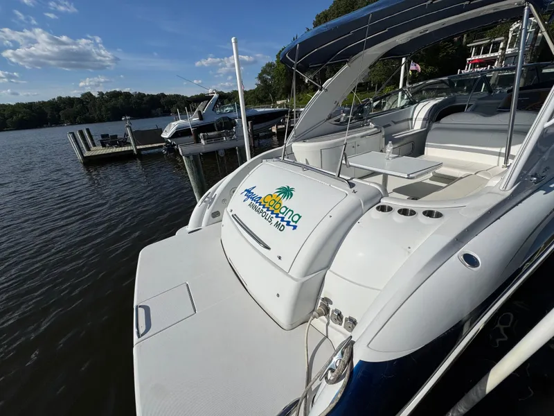 Slide: The Image of A white motorboat docked at a pier, surrounded by water and trees. - 8