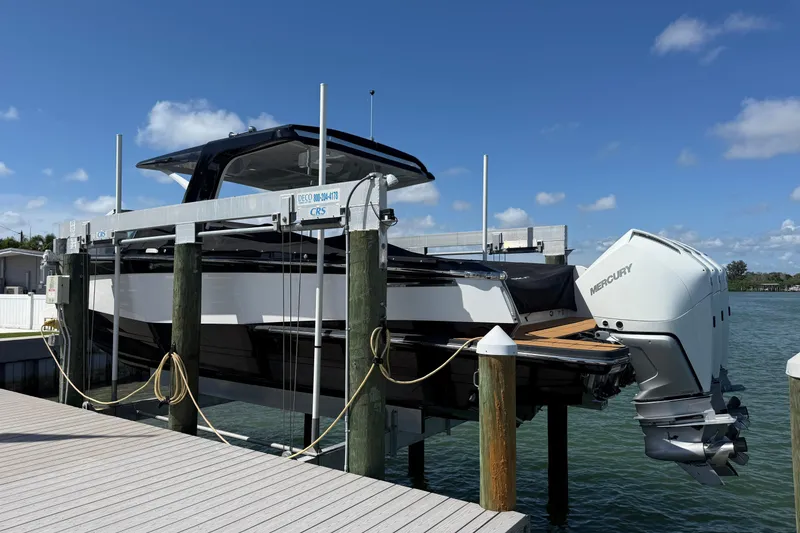Slide: The Image of 2023 Aviara AV36 OB boat with Mercury engines on a lift by the dock. - 12