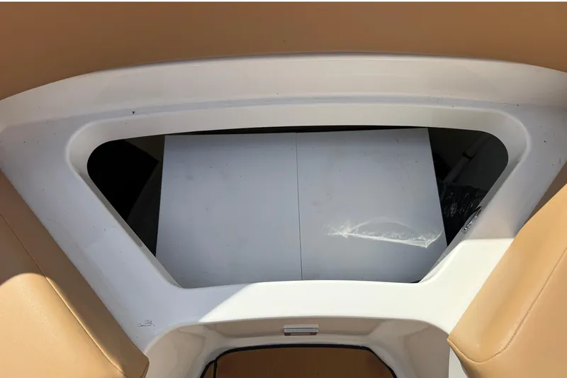 Slide: The Image of Interior view of a boat with beige upholstery and a white frame. - 19
