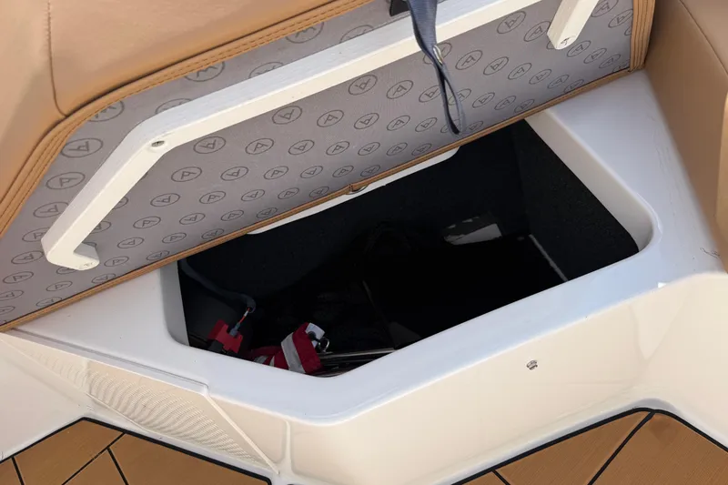 Slide: The Image of Storage compartment in 2023 Aviara AV36 OB boat, featuring cushioned lid and interior space. - 20