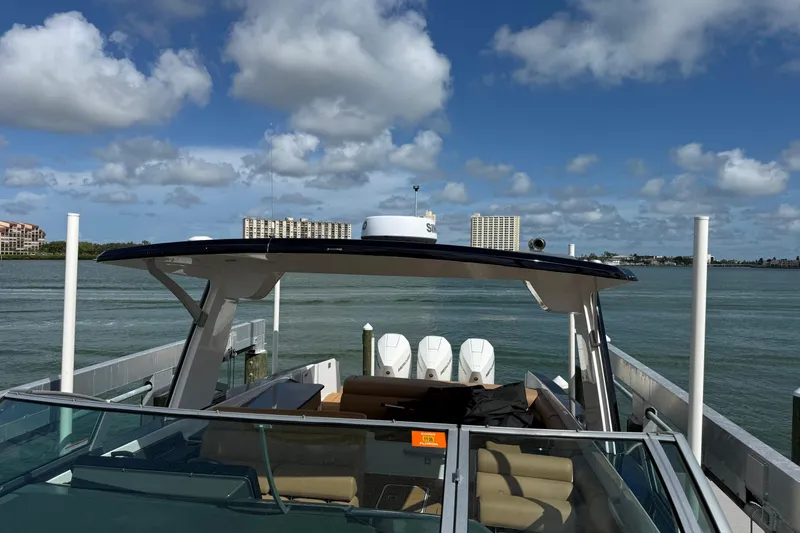 Slide: The Image of 2023 Aviara AV36 OB boat docked with scenic waterfront view and clear blue sky. - 22