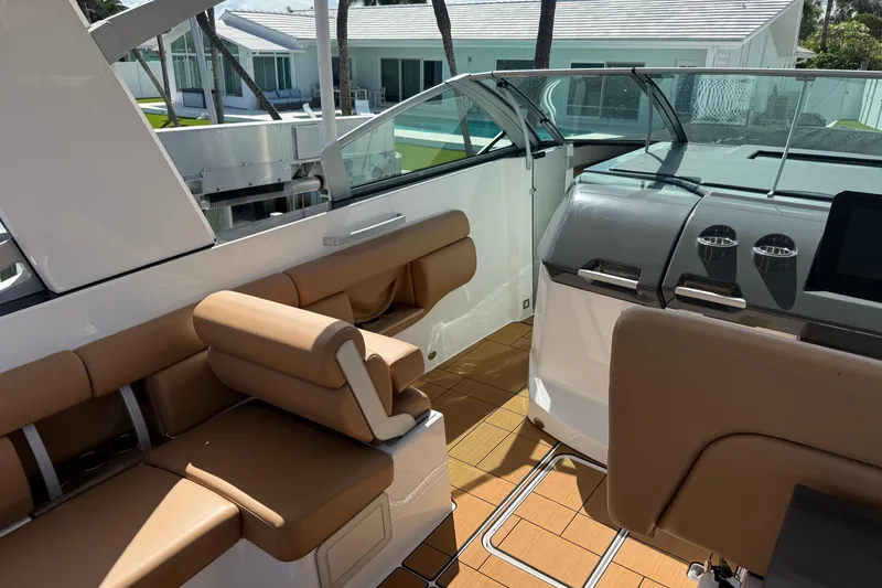 Slide: The Image of 2023 Aviara AV36 OB boat interior with tan seating and modern dashboard. - 26