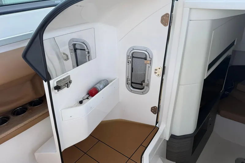 Slide: The Image of 2023 Aviara AV36 OB boat interior with storage compartment and fire extinguisher. - 28