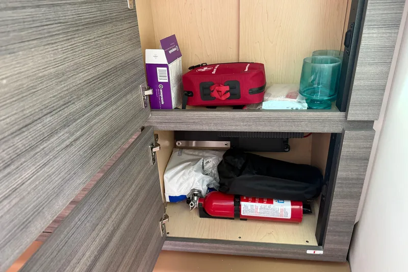 Slide: The Image of Cabinet storage in 2023 Aviara AV36 OB boat with safety equipment and supplies. - 32