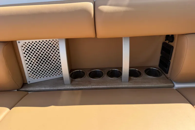 Slide: The Image of 2023 Aviara AV36 OB boat interior with tan seating and integrated cup holders. - 35