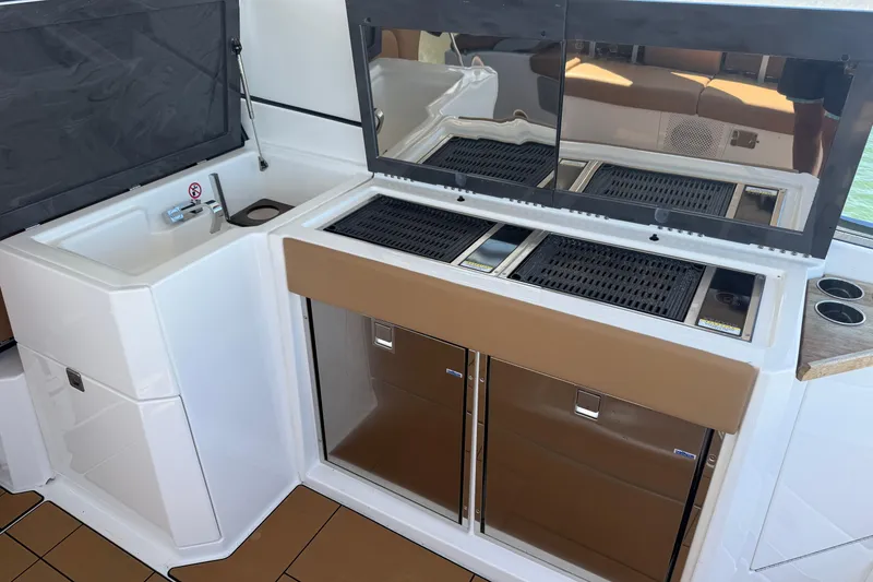 Slide: The Image of 2023 Aviara AV36 OB boat kitchen with sink, grill, and storage compartments. - 39