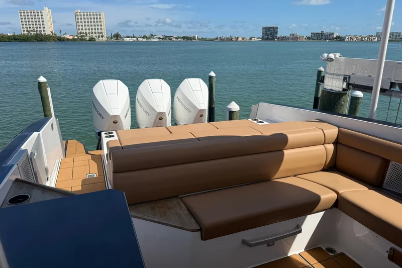Slide: The Image of 2023 Aviara AV36 OB boat with tan seating and triple Mercury outboard engines. - 42