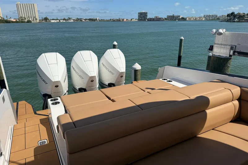 Slide: The Image of 2023 Aviara AV36 OB boat with triple Mercury outboard engines, docked by a scenic waterfront. - 43