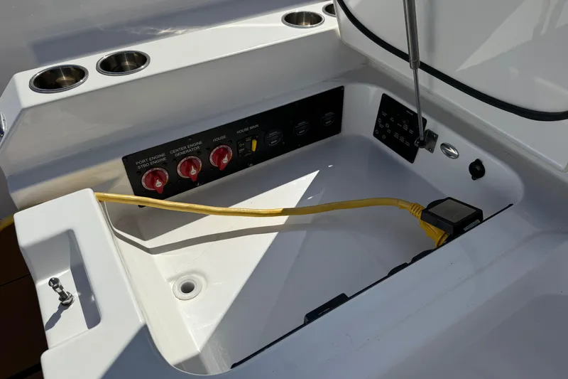 Slide: The Image of Control panel of 2023 Aviara AV36 OB boat with switches and yellow cable. - 47