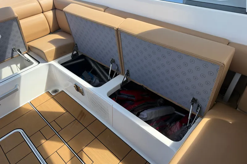 Slide: The Image of 2023 Aviara AV36 OB boat with open storage compartments and tan seating. - 50