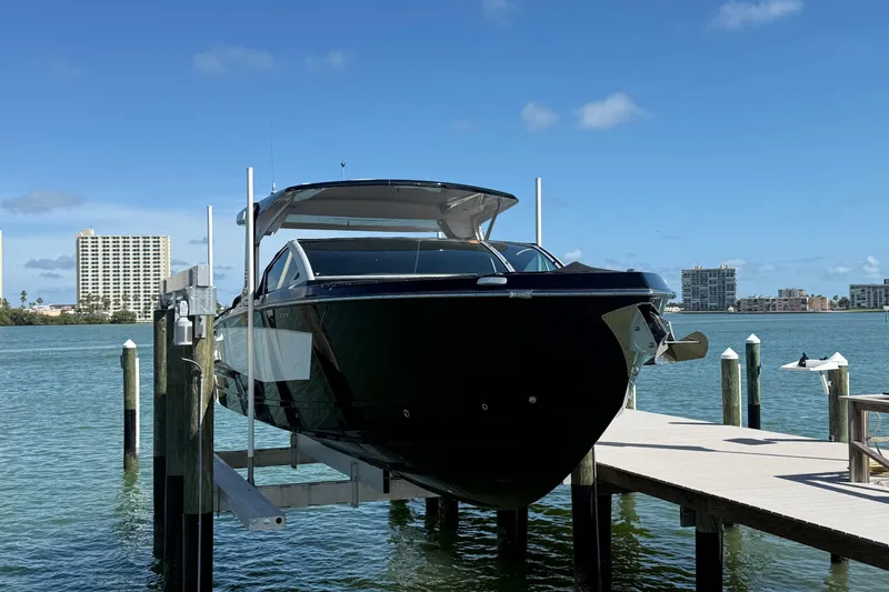 Slide: The Image of 2023 Aviara AV36 OB boat docked by waterfront with city skyline in background. - 6