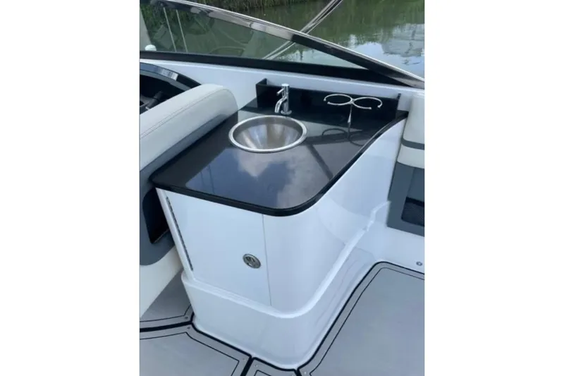 Slide: The Image of 2021 Cobalt 30SC boat interior with sleek sink and countertop design. - 10