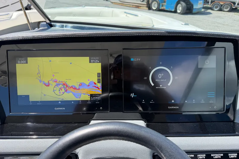Slide: The Image of Garmin navigation and control screens on a 2021 Cobalt 30SC boat dashboard. - 29