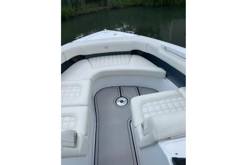 Slide: The Image of 2021 Cobalt 30SC boat interior with white cushioned seating and sleek design. - 11