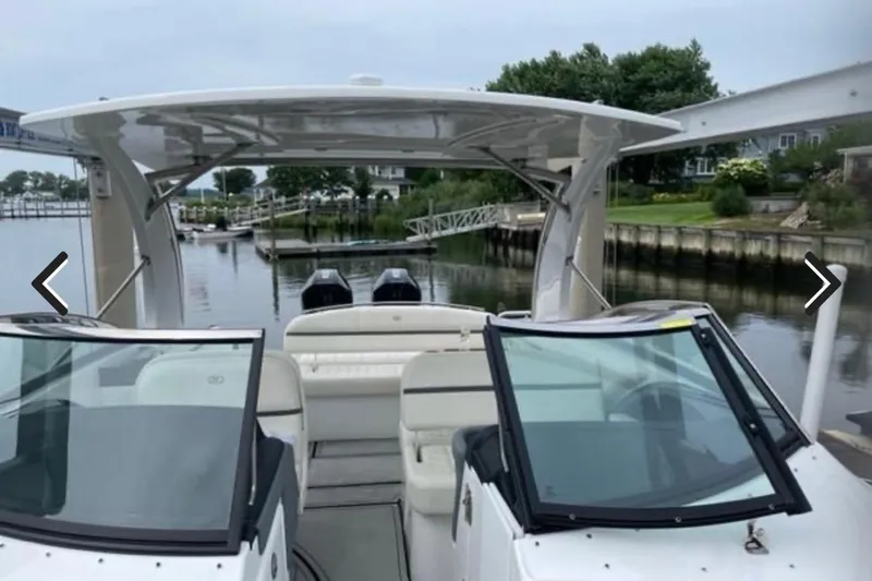 Slide: The Image of 2021 Cobalt 30SC boat docked in a serene marina setting. - 12