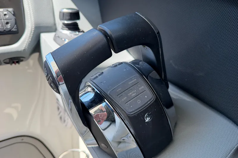 Slide: The Image of Close-up of 2021 Cobalt 30SC boat throttle control, featuring sleek design and modern buttons. - 24