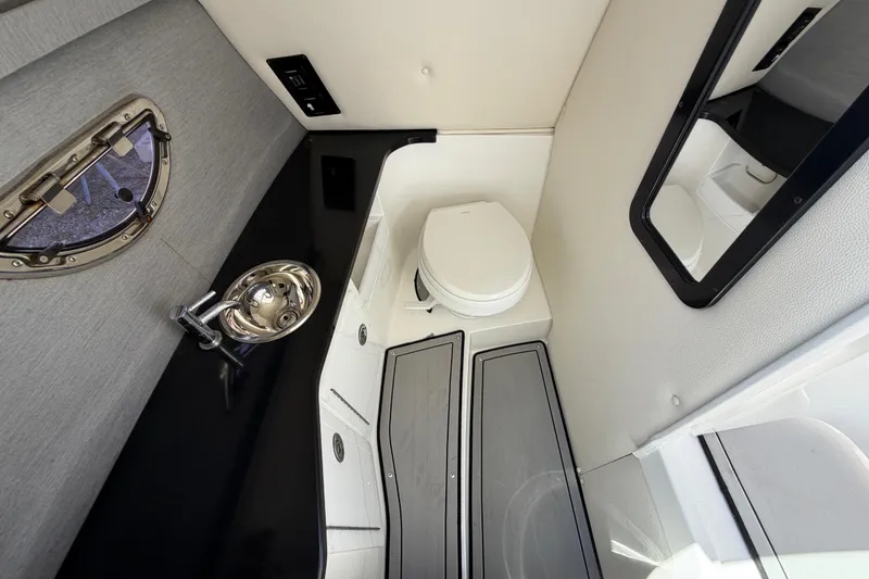 Slide: The Image of 2021 Cobalt 30SC boat interior bathroom with sink, toilet, and mirror. - 34