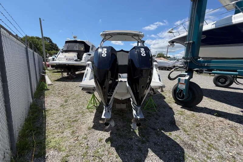 Slide: The Image of 2021 Cobalt 30SC boat with dual 300 horsepower engines in a marina setting. - 6