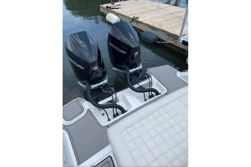 Slide: The Image of 2021 Cobalt 30SC boat with dual Mercury outboard engines docked by a pier. - 4