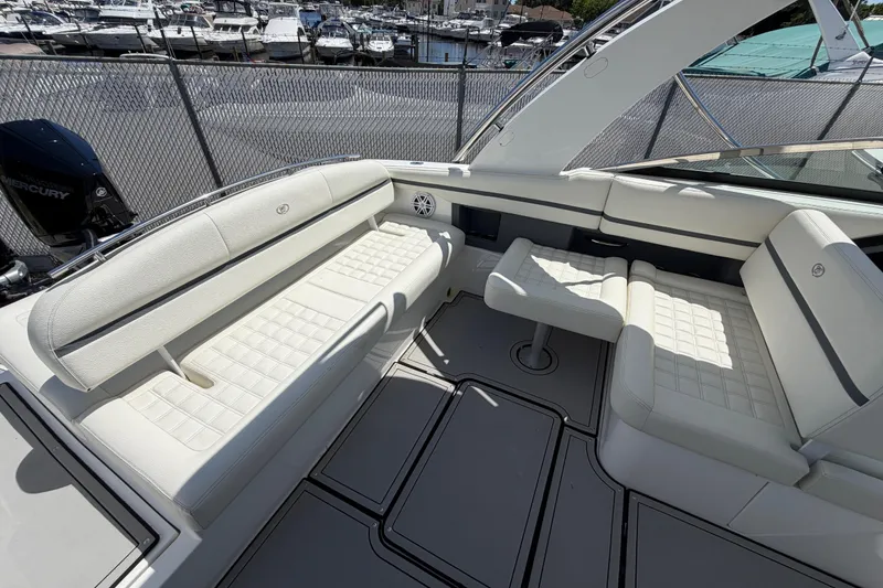 Slide: The Image of 2021 Cobalt 30SC boat interior with white seating, docked at marina. - 19