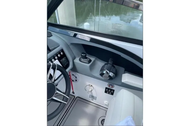 Slide: The Image of 2021 Cobalt 30SC boat helm with steering wheel and controls. - 7