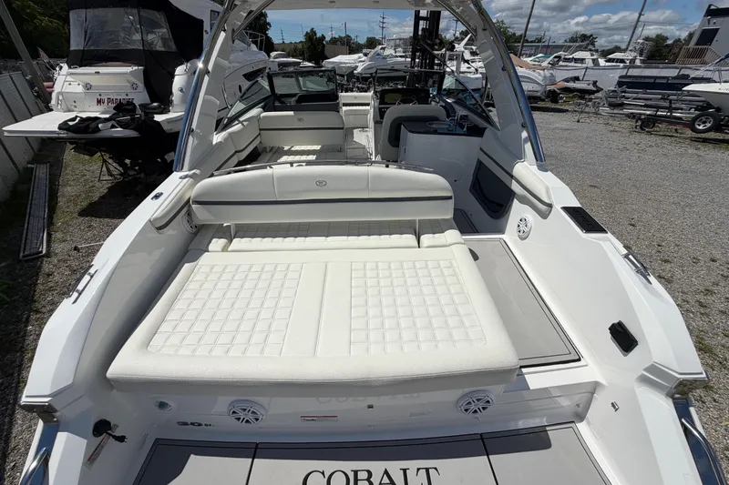 Slide: The Image of 2021 Cobalt 30SC boat with spacious seating and sleek design, docked outdoors. - 10