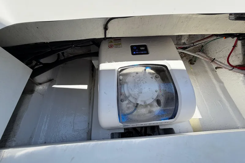 Slide: The Image of Engine compartment of 2021 Cobalt 30SC boat, featuring mechanical components and wiring. - 14