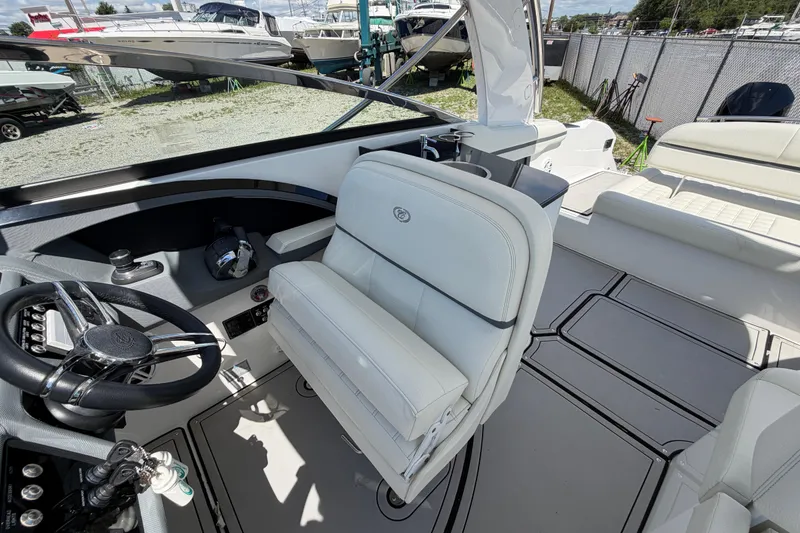 Slide: The Image of 2021 Cobalt 30SC boat interior with white seating and modern steering wheel. - 22