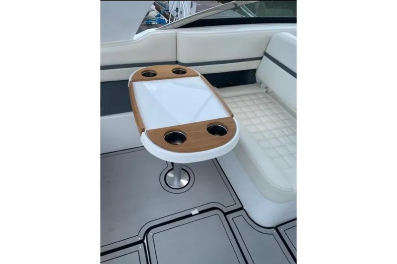Slide: The Image of Luxury seating area on 2021 Cobalt 30SC boat with stylish table and cup holders. - 9