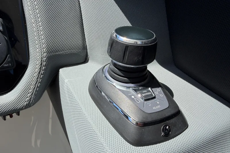 Slide: The Image of Joystick control panel on 2021 Cobalt 30SC boat, featuring textured surface and adjustment buttons. - 25