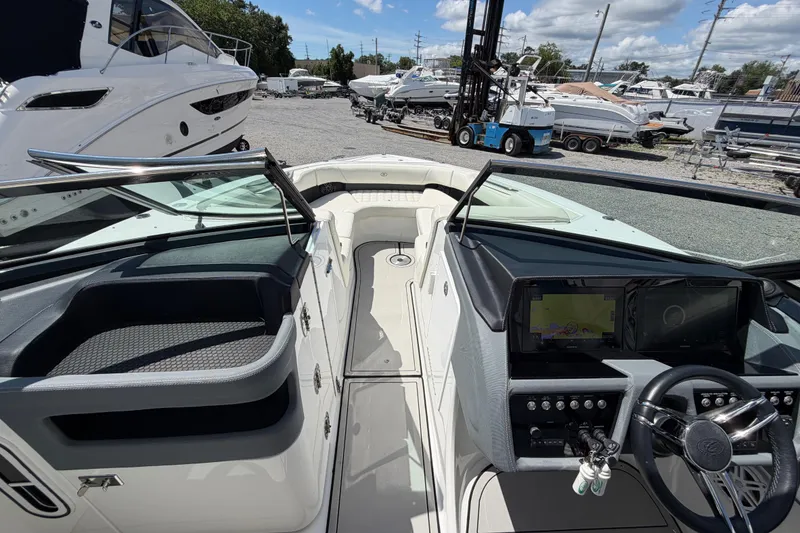 Slide: The Image of Interior view of a 2021 Cobalt 30SC boat, featuring a sleek dashboard and steering wheel. - 40