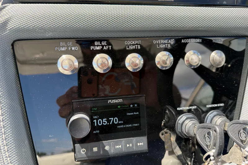 Slide: The Image of Control panel of a 2021 Cobalt 30SC boat with switches and radio display. - 30