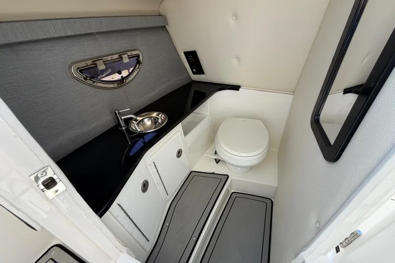 Slide: The Image of 2021 Cobalt 30SC boat interior bathroom with sink, toilet, and modern design. - 33
