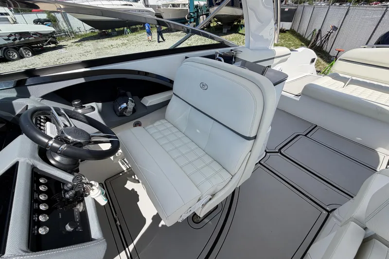 Slide: The Image of 2021 Cobalt 30SC boat interior with white seating and modern steering console. - 23