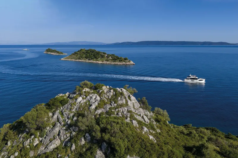 Slide: The Image of Luxury yacht Absolute 70 Fly cruising near scenic islands, 2027 model. - 12