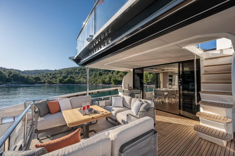 Slide: The Image of Luxurious 2027 Absolute 70 Fly yacht with elegant outdoor seating and scenic water views. - 20