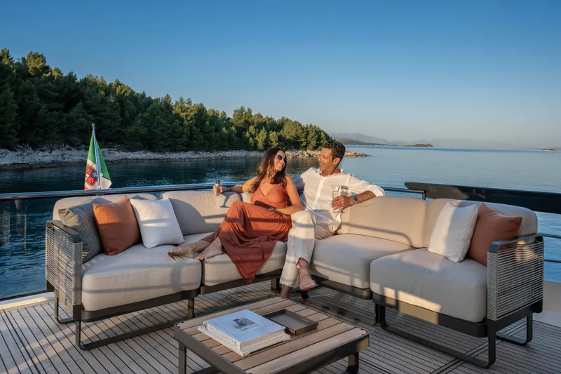 Slide: The Image of Couple relaxing on Absolute 70 Fly yacht, 2027, enjoying serene ocean view. - 27