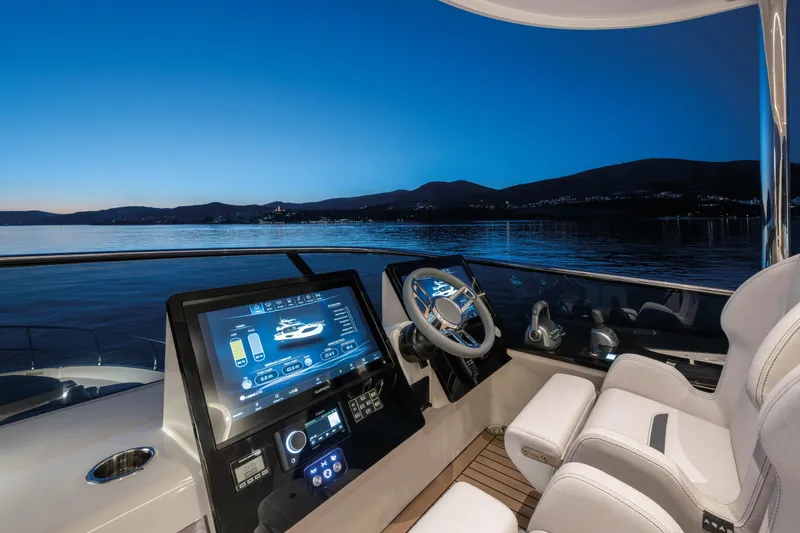 Slide: The Image of Luxurious 2027 Absolute 70 Fly yacht cockpit at sunset, featuring advanced navigation controls. - 28
