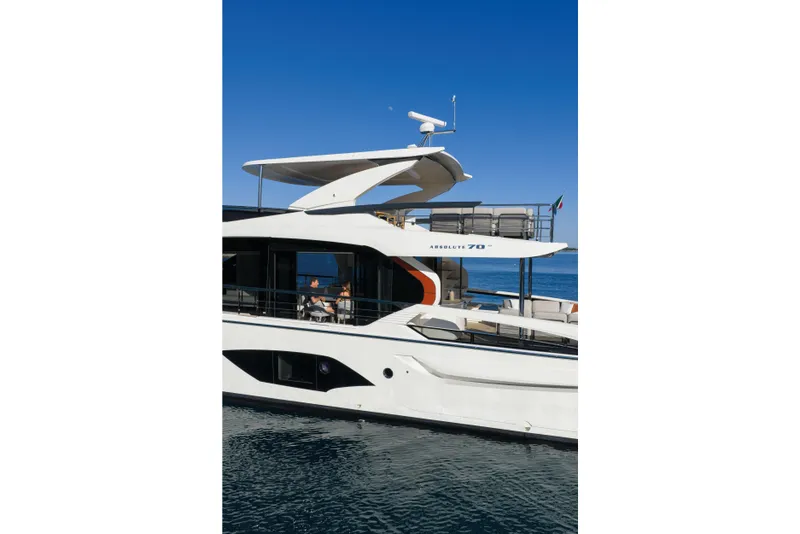 Slide: The Image of Luxury Absolute 70 Fly yacht, 2027 model, cruising on clear blue waters. - 29