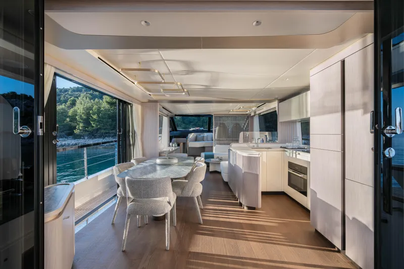 Slide: The Image of Luxurious interior of 2027 Absolute 70 Fly yacht with modern dining and kitchen area. - 31
