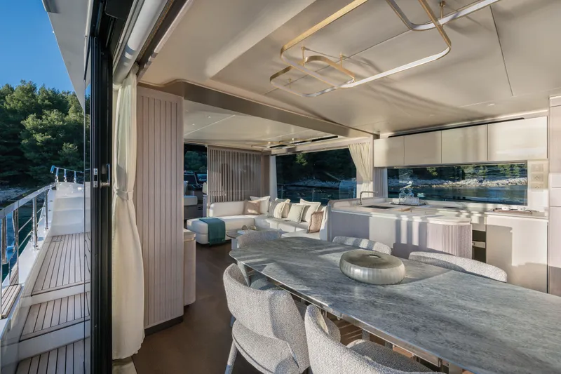 Slide: The Image of Luxurious interior of 2027 Absolute 70 Fly yacht with elegant dining and lounge area. - 33