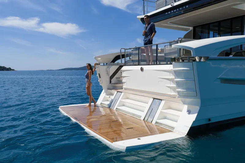 Slide: The Image of A luxury yacht with two people on deck, surrounded by blue water. - 10