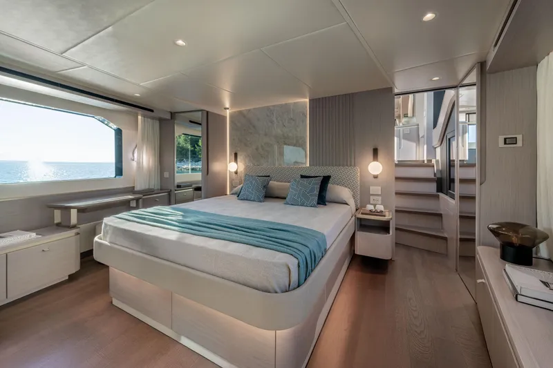 Slide: The Image of Luxurious bedroom on a yacht with a large bed, window view of the sea, and modern decor. - 29