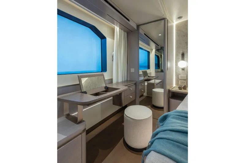 Slide: The Image of Elegant yacht interior with large window, vanity desk, and stool. - 31