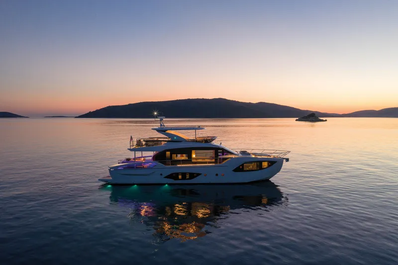 Slide: The Image of Luxury yacht at sunset on calm water, surrounded by hills. - 8
