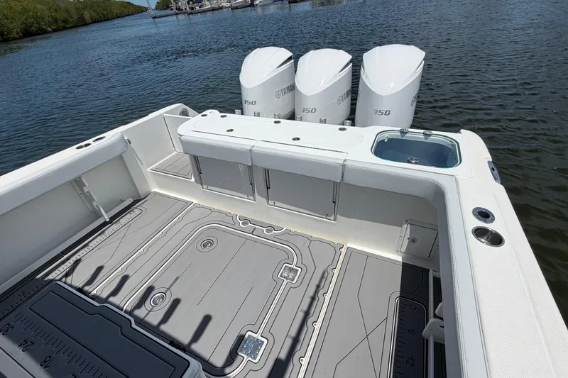 Slide: The Image of 2009 Everglades 350LX boat with triple Yamaha 350 engines on a calm waterway. - 12