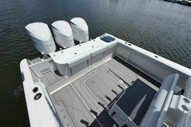 Slide: The Image of 2009 Everglades 350LX boat with triple Yamaha 350 engines on water. - 13
